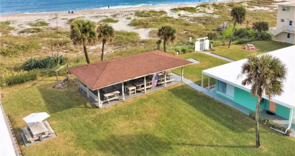 Cocoa Beach motel exterior with parking area and simple traveler-friendly amenities near the coastline