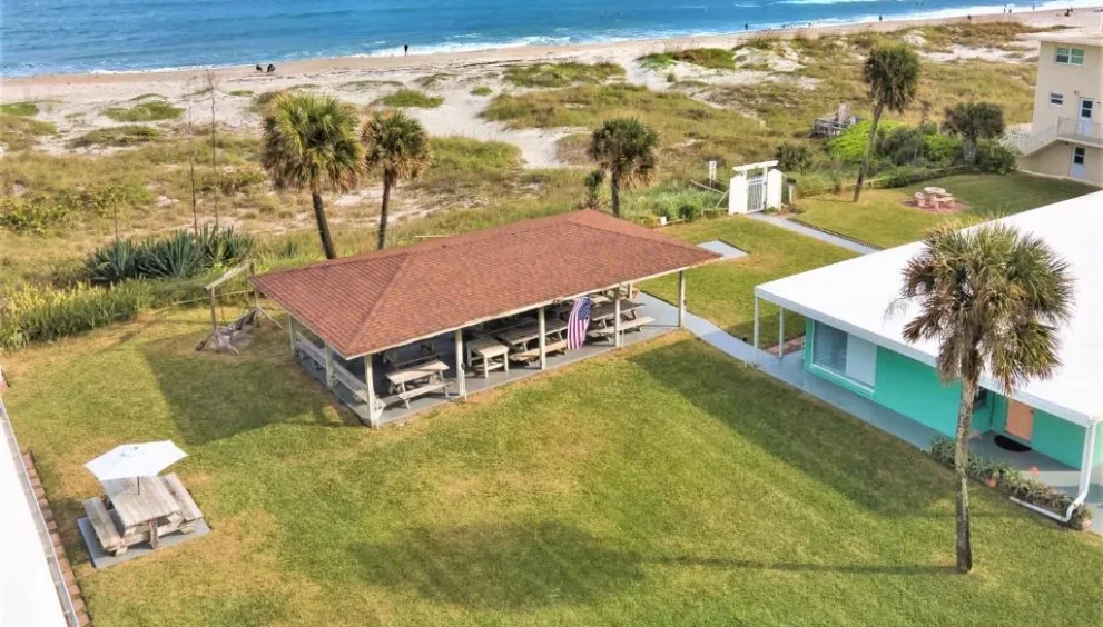 Cocoa Beach motel exterior with parking area and simple traveler-friendly amenities near the coastline